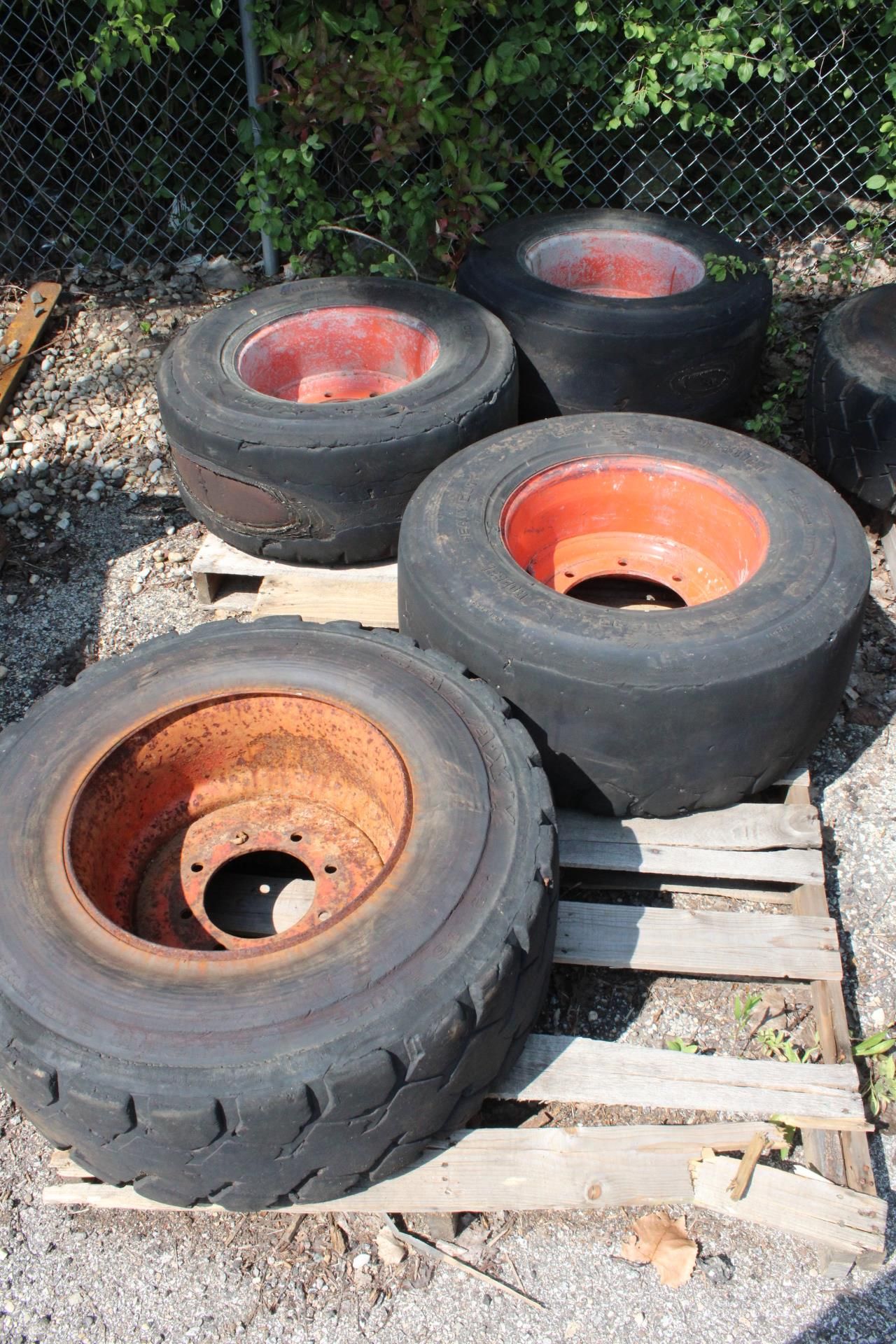 (4) SKID STEER TIRES WITH RIMS