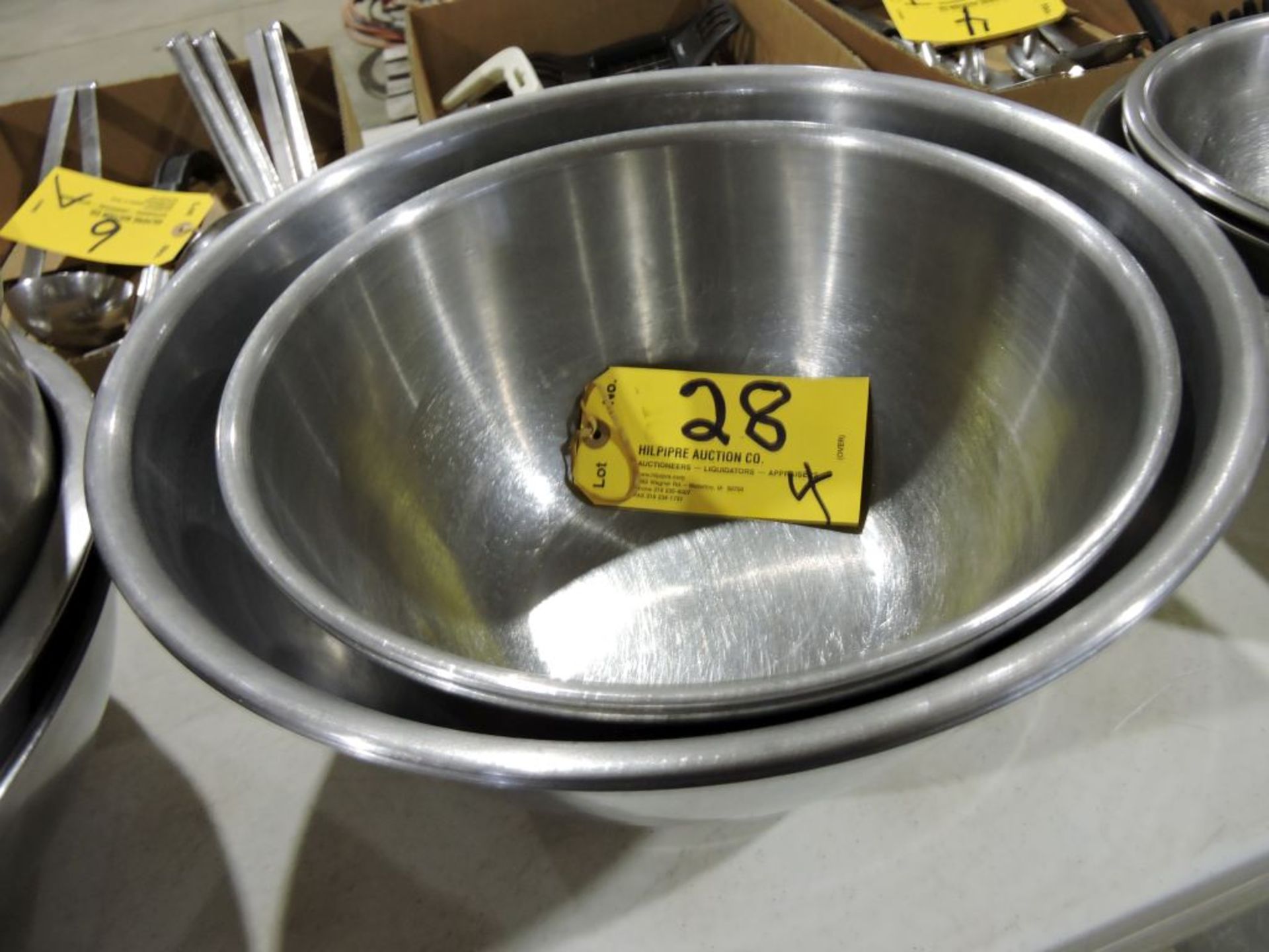 Deep stainless steel mixing bowls.
