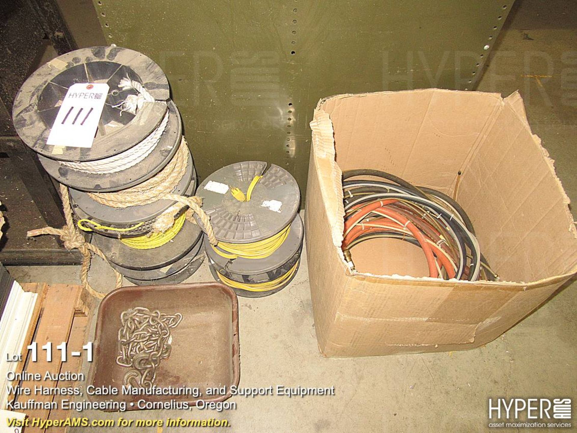 Assorted spools of rope, extension cords, jumper cables, and more