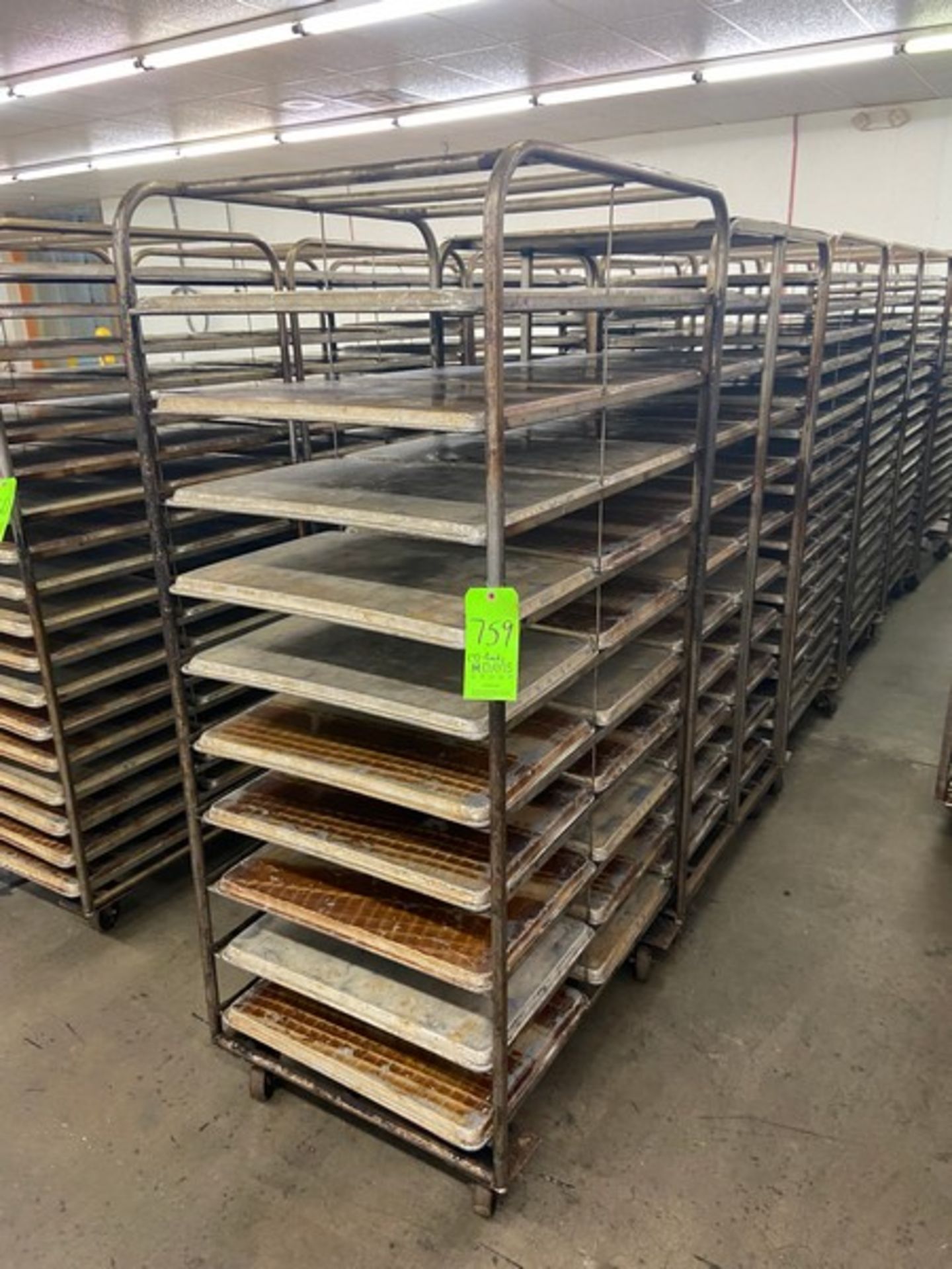 (7) PORTABLE DOUBLE SIDED BAKING PAN RACKS, MOUNTED ON CASTERS (LOCATED IN HERMITAGE, PA)