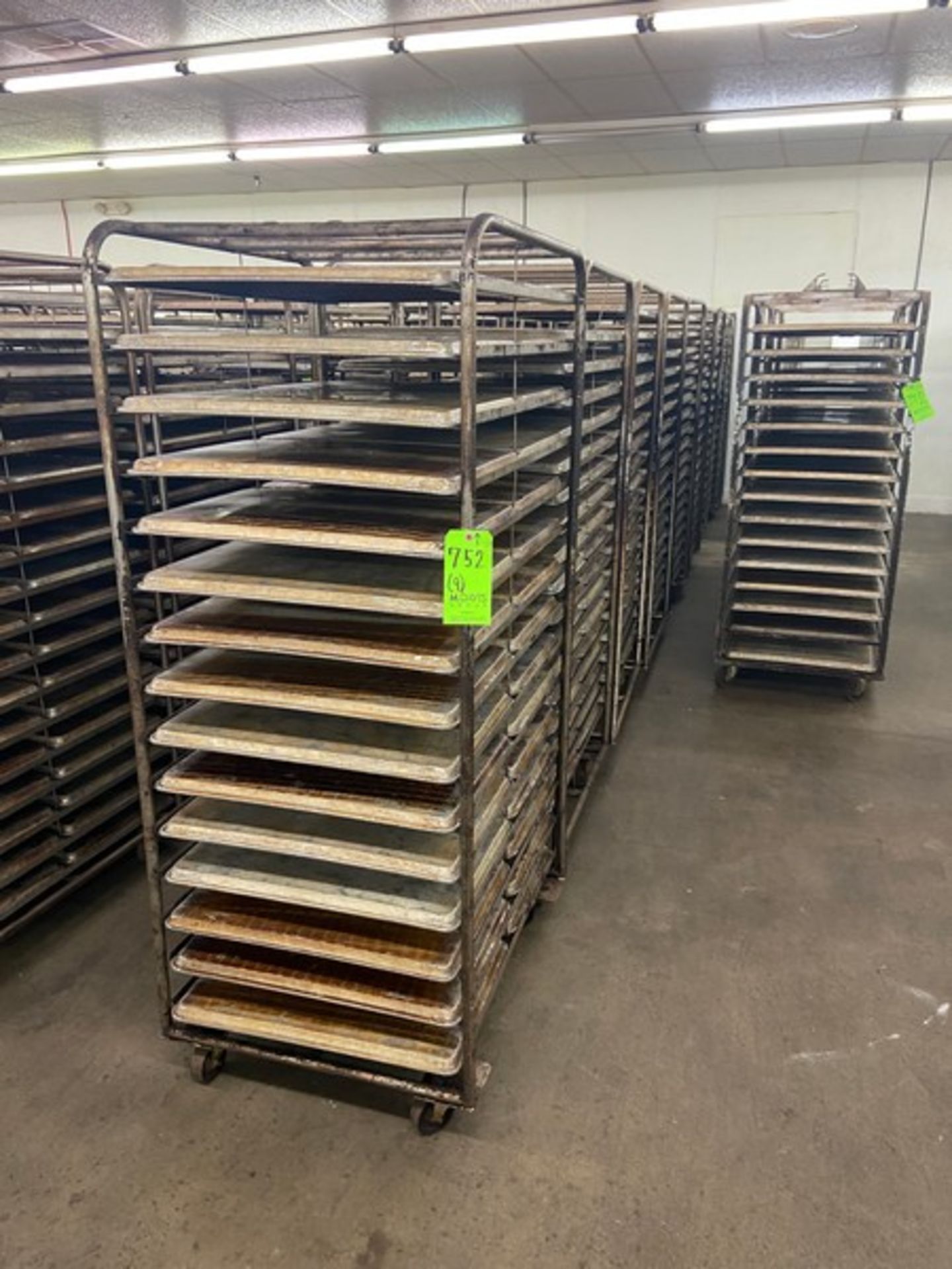 (9) PORTABLE DOUBLE SIDED BAKING PAN RACKS, MOUNTED ON CASTERS (LOCATED IN HERMITAGE, PA)