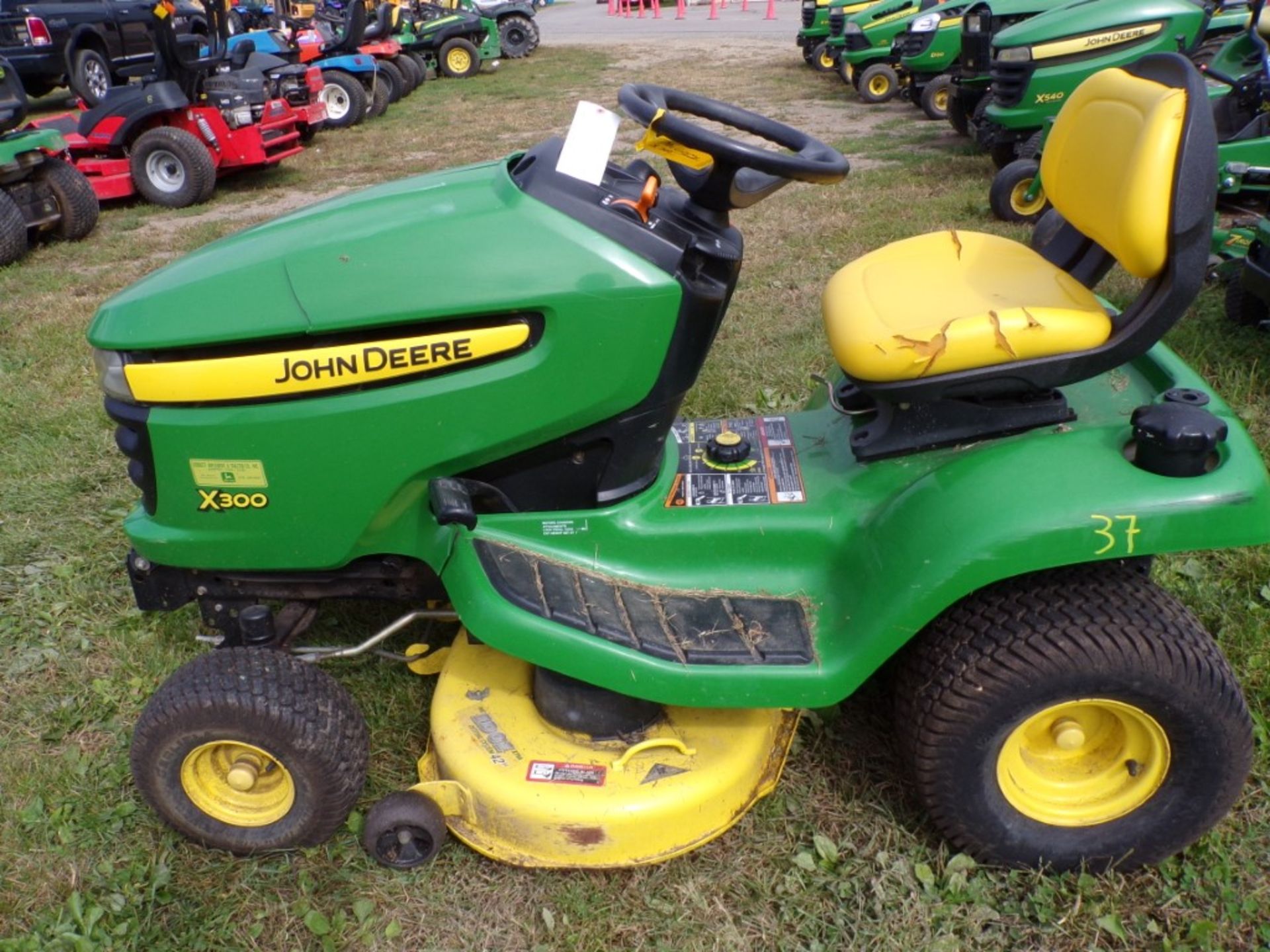 John Deere X300 Riding Mower w/42'' Deck, Kawasaki Engine, Hood & Seat Have Damage, 698 Hours,