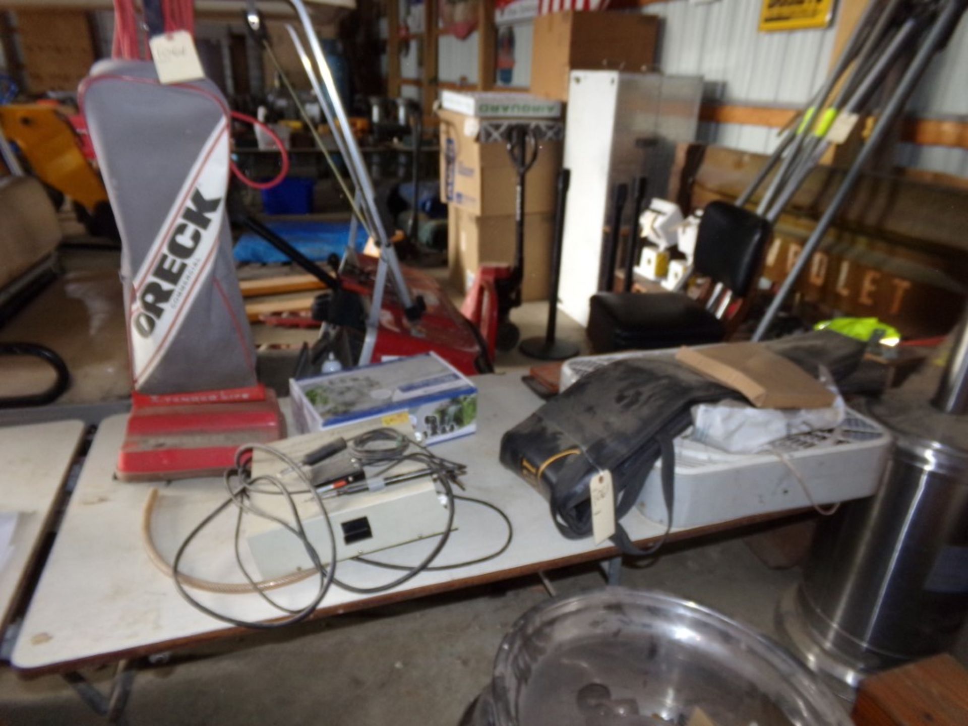 Group Of Misc. Items On Table, Box Fan, Oreck Vacuum, Check Valve For Landscape Pond, Etc., Includes
