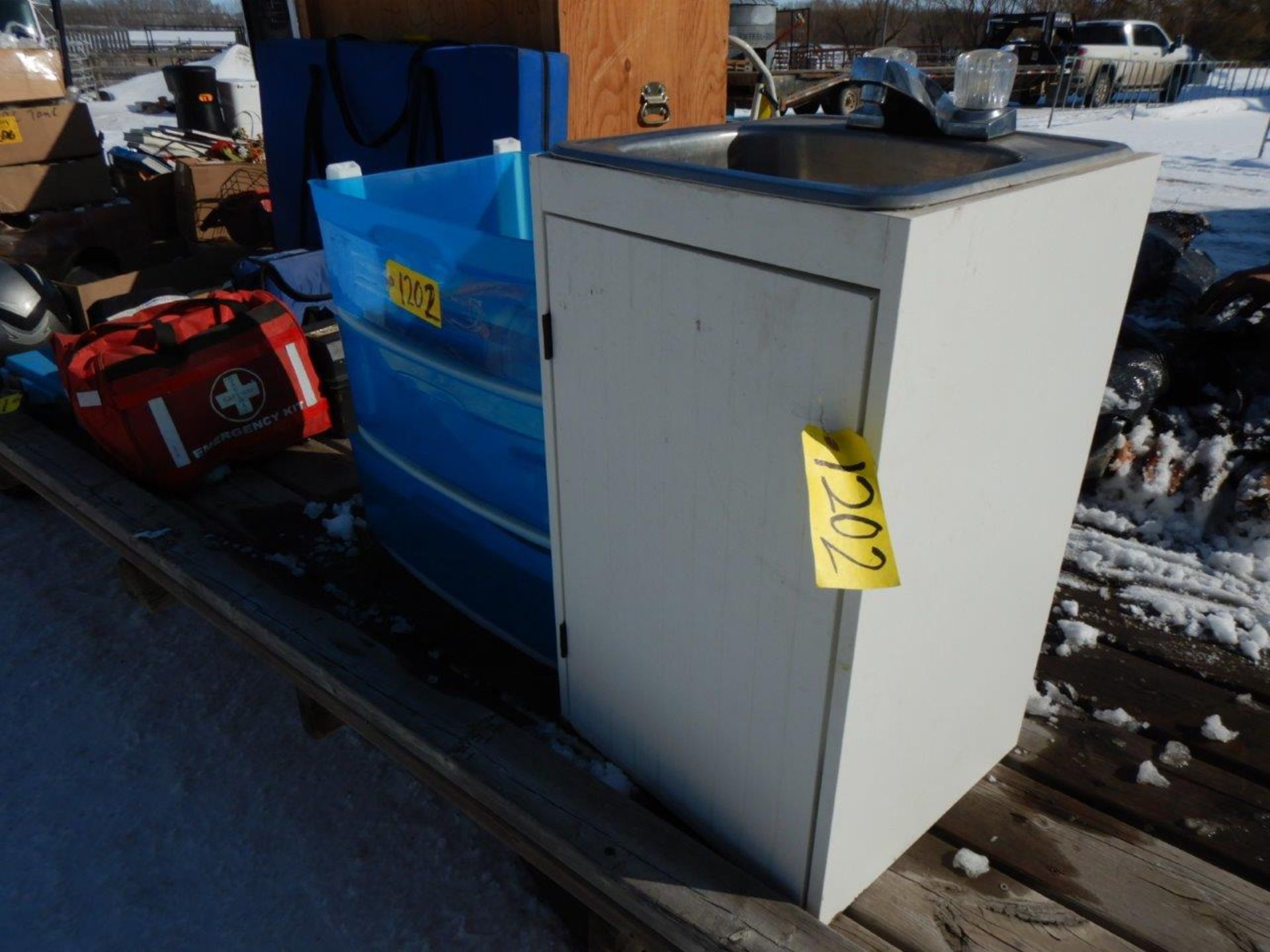 SS SINGLE COMPARTMENT SINK IN CABINET AND POLY STORAGE UNIT (MISSING TOP)