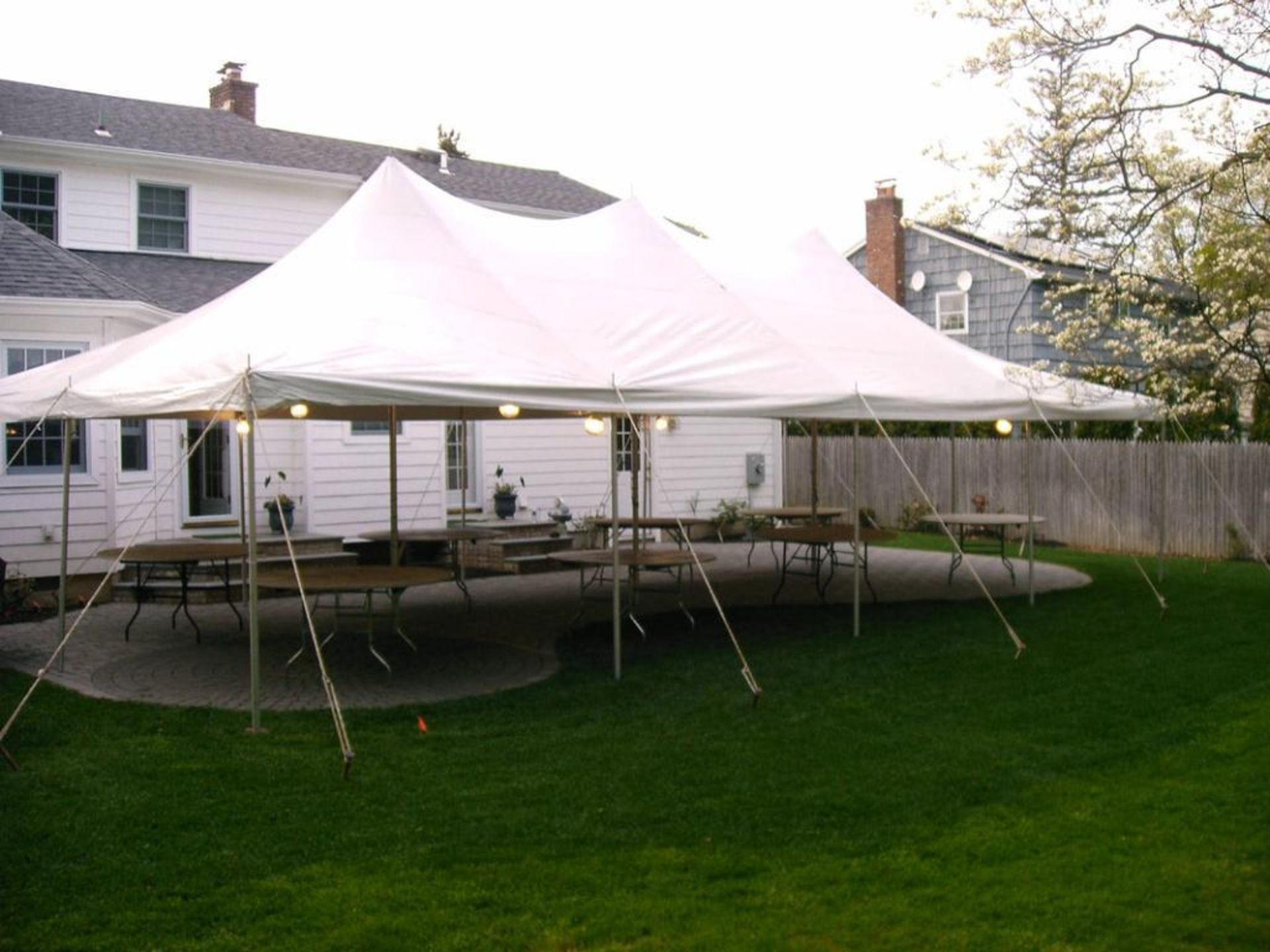 LOT: Eureka 20' x 40' White Canopy, (36) Poles, (16) Stakes (THE PICTURE OF THE SET UP TENT/CANOPY A