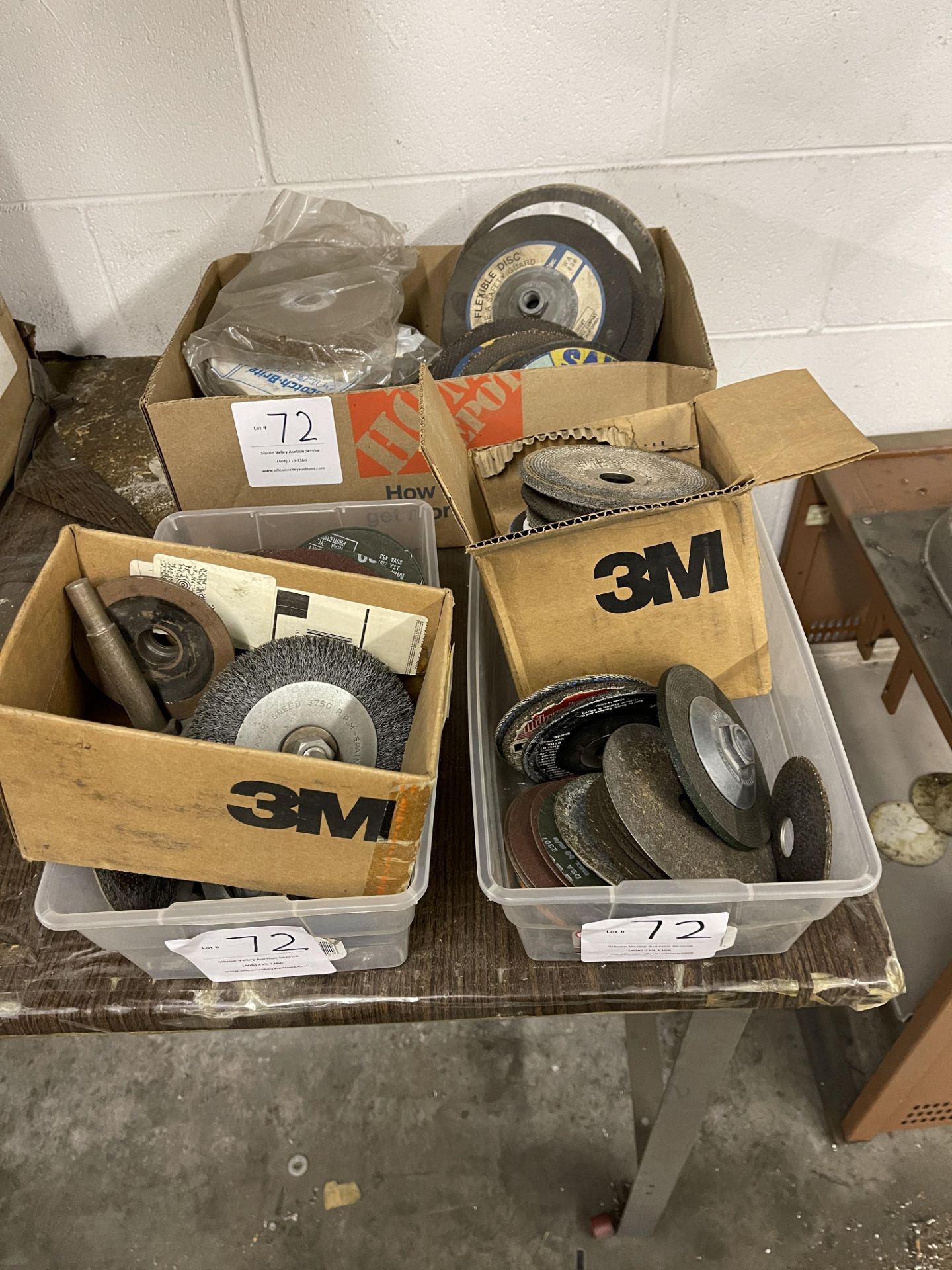 Three containers of sanding disks and grinding disks