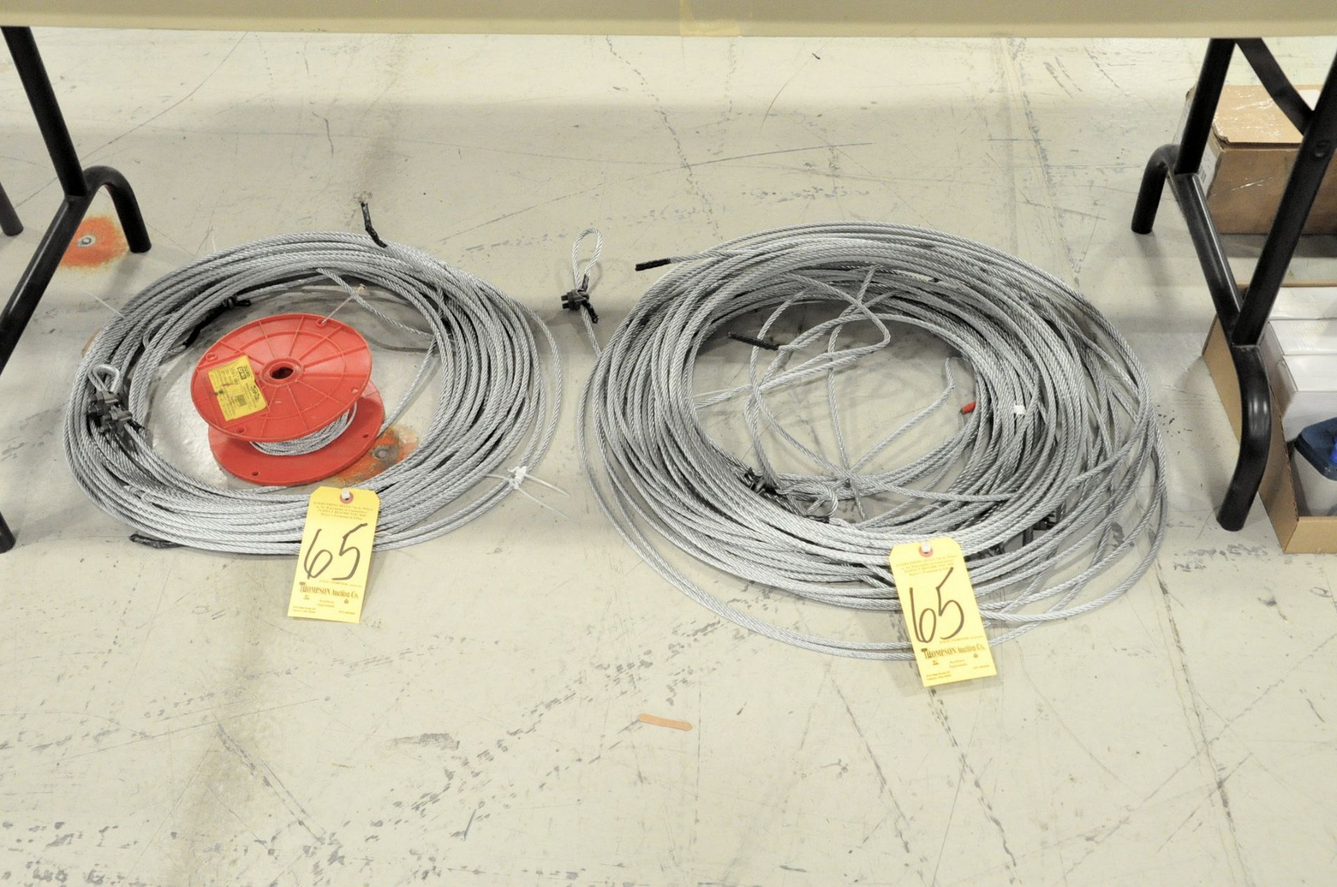 Lot-(2) Various Steel Wire Ropes and Small Spool of Cable on Floor Under (1) Table