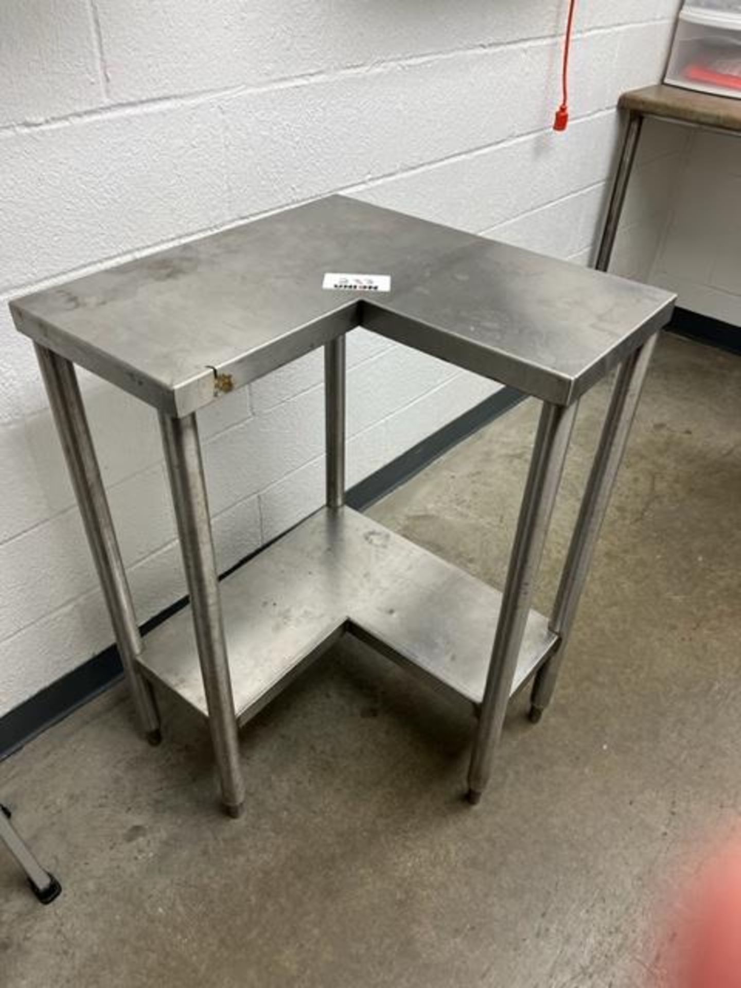 Asset 233 - Stainless steel L-shape table. $345.00 Rigged and packed on 48" x 40" pallet banded