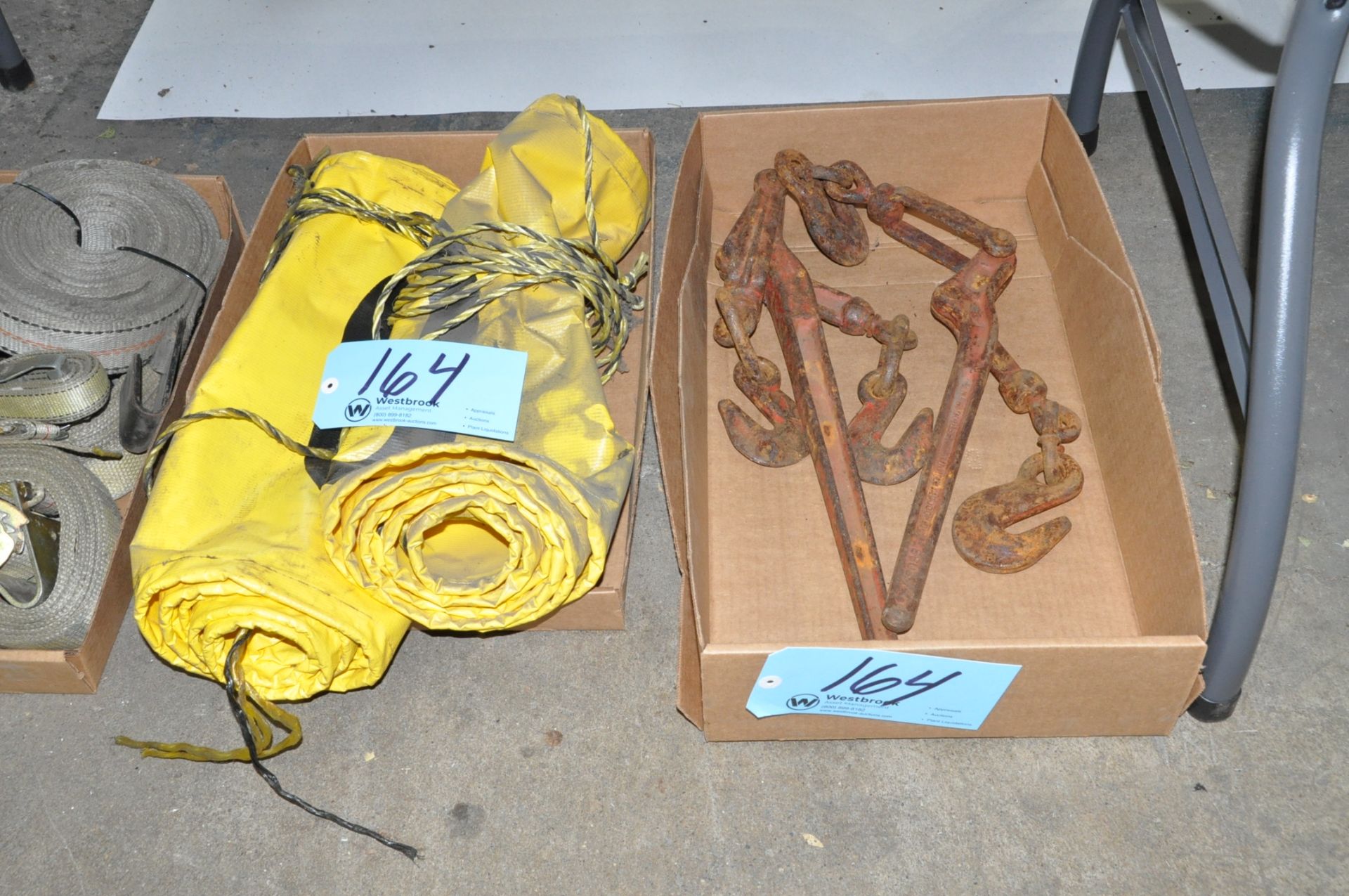 Lot-(2) Chain Binders and (2) Caution Banners in (1) Box on Floor Under (1) Table