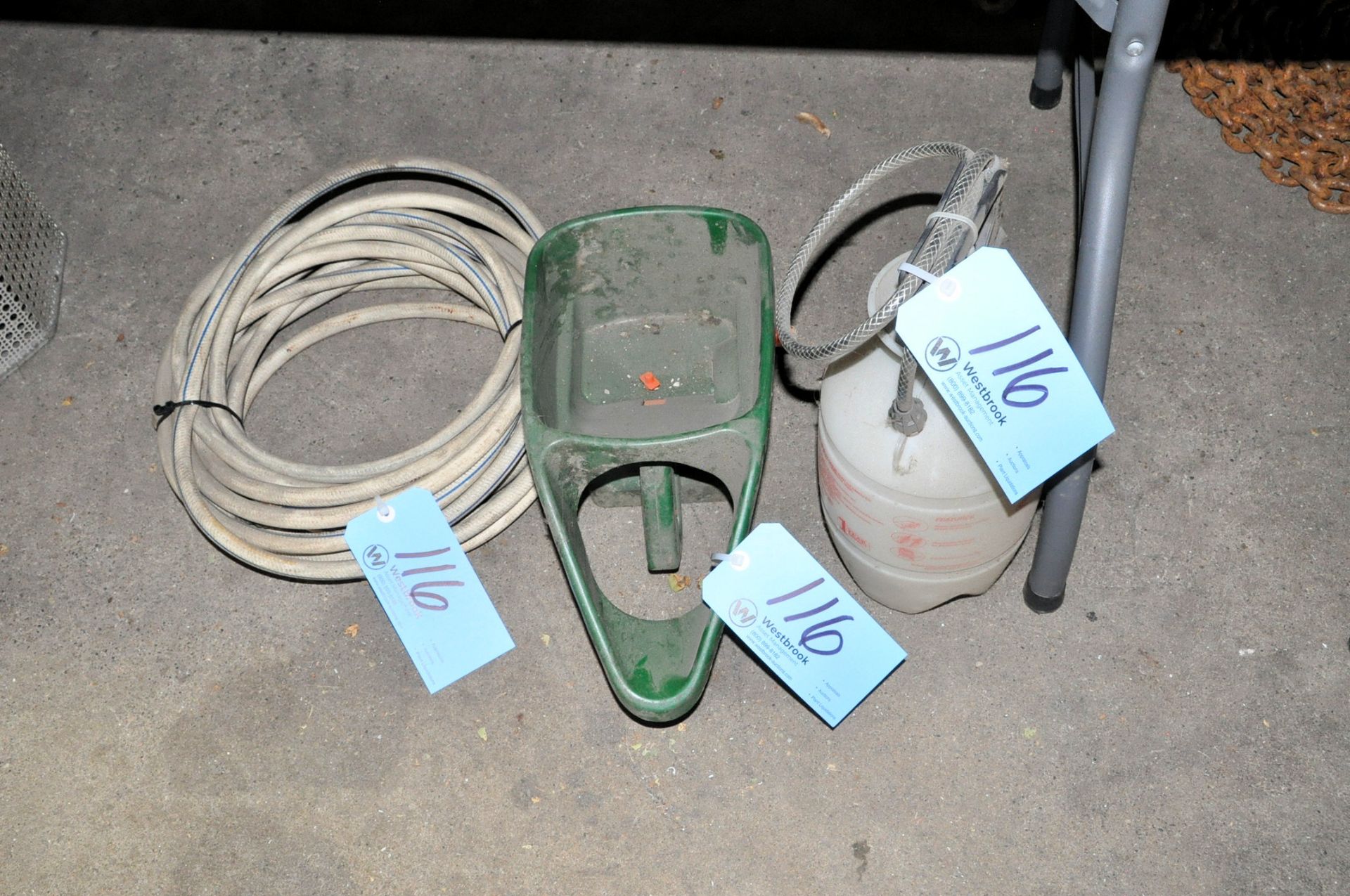 Lot-(1) Garden Pump Sprayer, (1) Hose, and (1) Spreader on Floor Under (1) Table