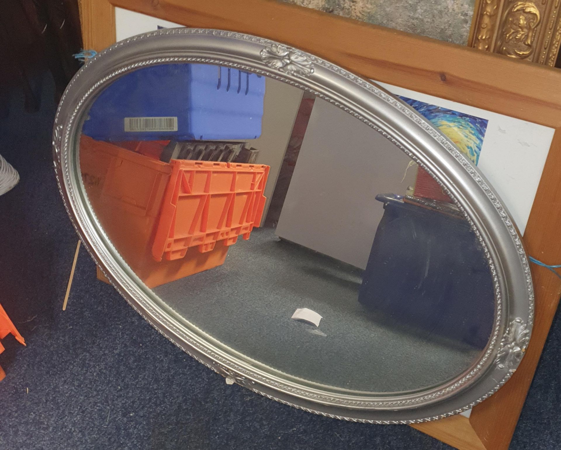 Large oval framed mirror