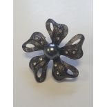 Lovely black centre stone flower brooch