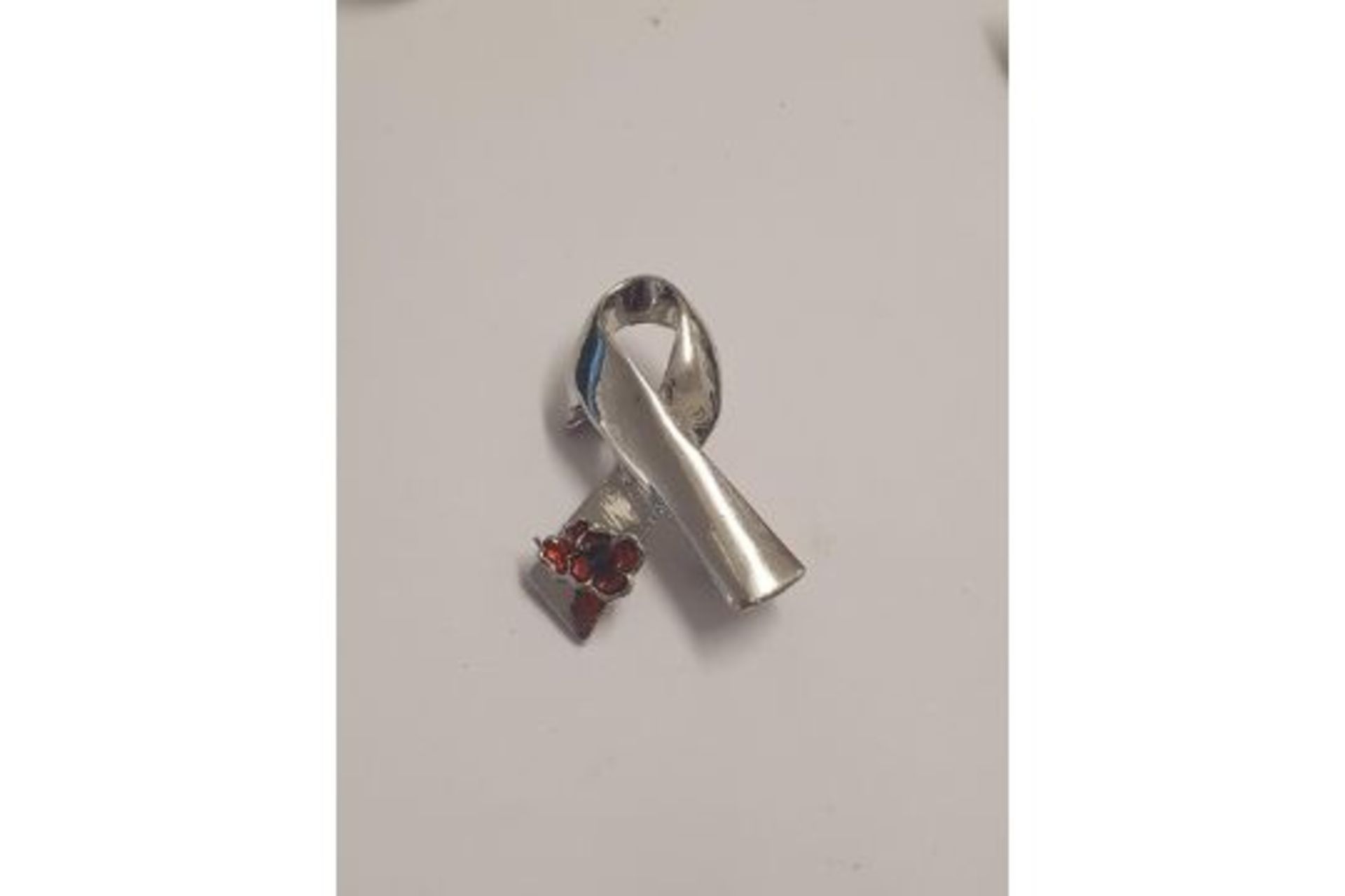 silver coloured ribbon pin