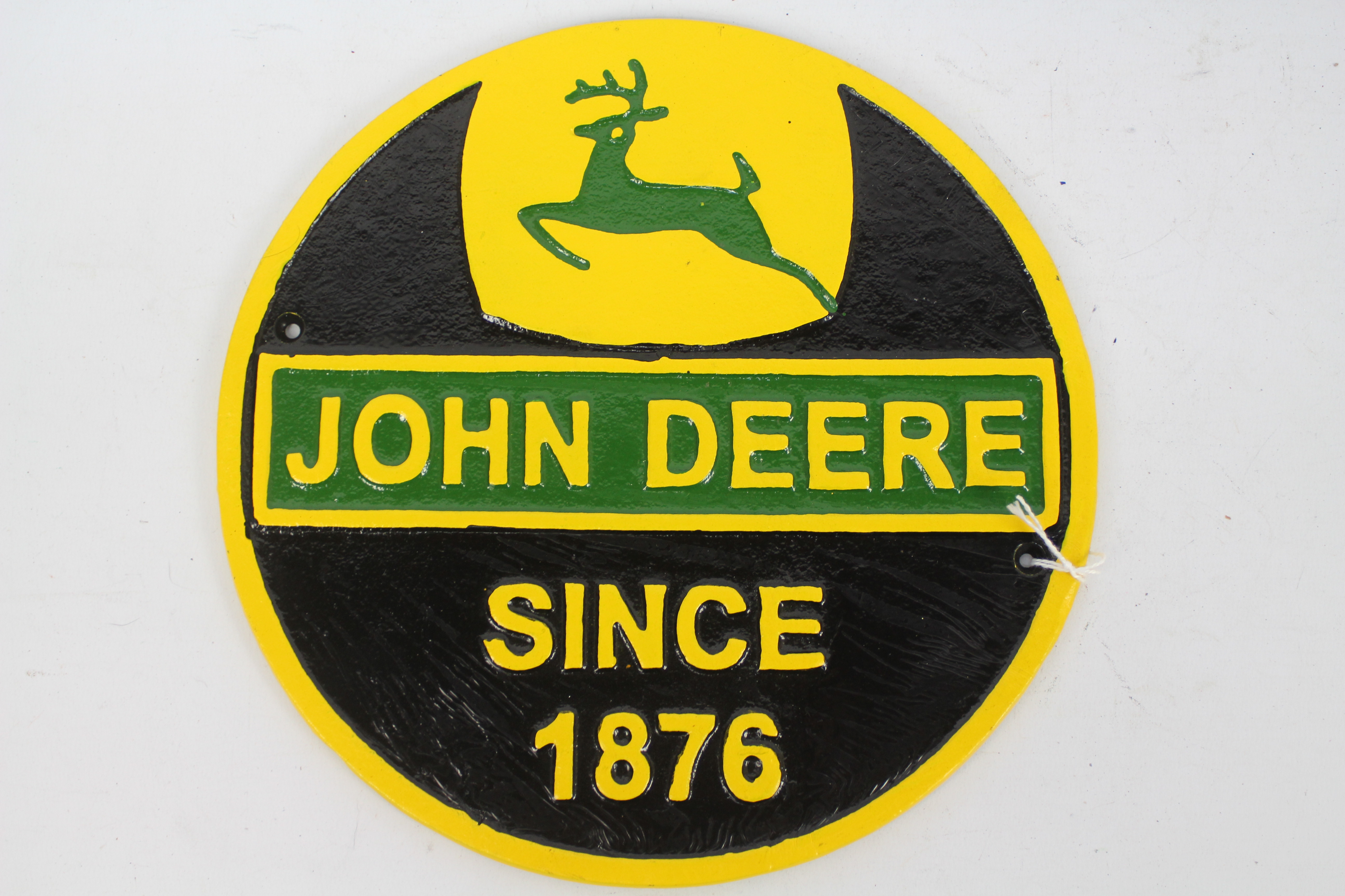 A cast iron wall plaque marked John Deere, 24 cm (d).