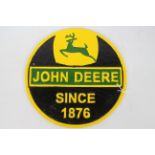 A cast iron wall plaque marked John Deere, 24 cm (d).