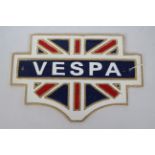 A cast iron wall plaque with Union Flag decoration, marked Vespa, approximately 20 cm x 30 cm.