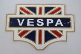 A cast iron wall plaque with Union Flag decoration, marked Vespa, approximately 20 cm x 30 cm.