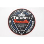 A cast iron wall plaque marked Triumph Bonneville, approximately 24 cm (d).