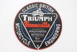 A cast iron wall plaque marked Triumph Bonneville, approximately 24 cm (d).