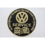 A cast iron wall plaque marked VW Service, approximately 24 cm (d).