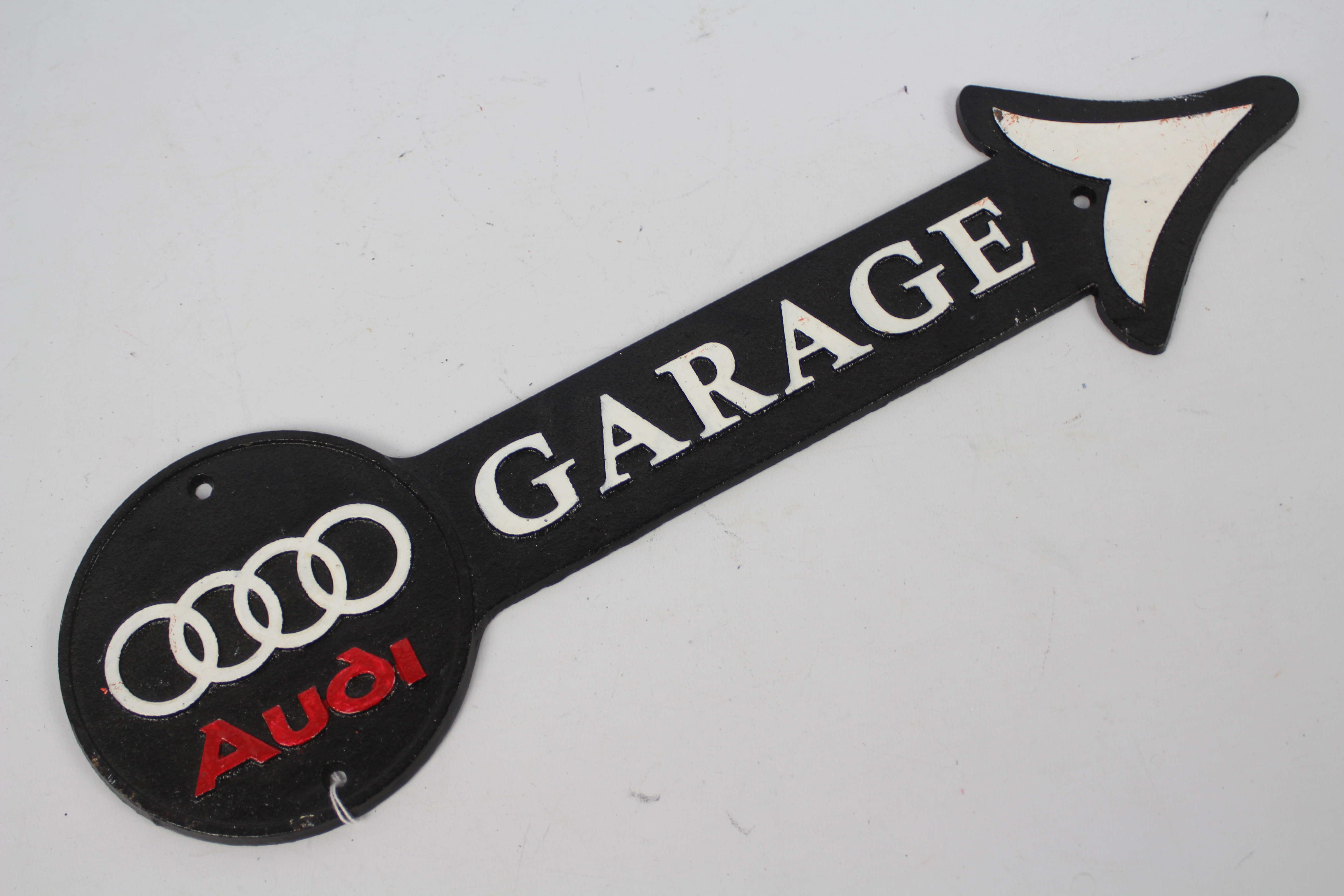 A wall mountable, cast iron, garage directional sign bearing Audi logo, 44 cm (l).