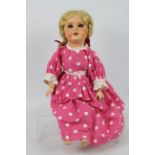 Unis - A vintage Unis France composite doll with blue sleeping eyes and open mouth showing upper