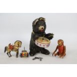 A collection of vintage clockwork and tinplate toys including a Drumming Bear which is approx 20 cm