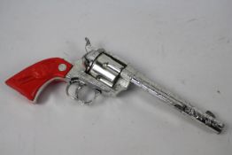 Crescent Toy Company - A Crescent toy Rustler 45 cap gun with working mechanism.