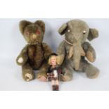 Armand Marseille - A German made bisque head doll with two vintage soft toys.