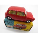 Corgi - a diecast model Austin Seven Mini, red body and chassis, cream interior, steering wheel,
