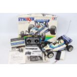 Tamiya - A boxed vintage 1980s radio control Tamiya Striker off road racer in 1:10 scale.