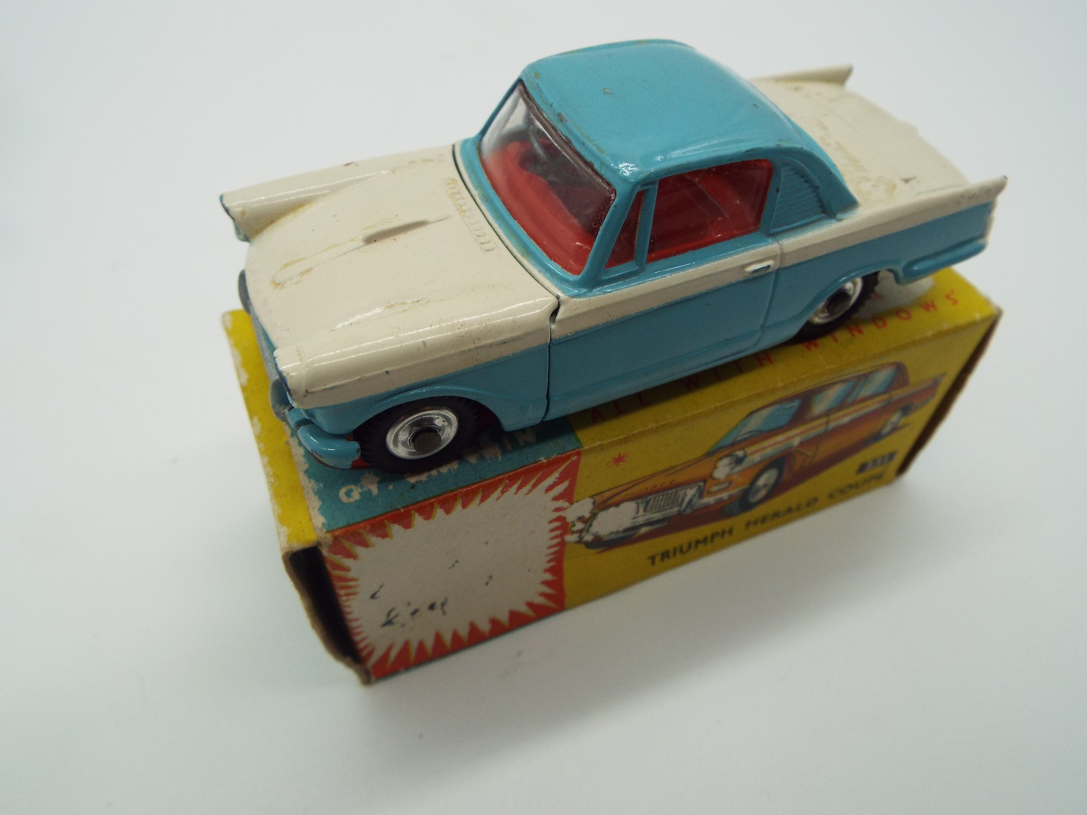 Corgi - a diecast model Triumph Herald Coupe, the bonnet opening to reveal the engine,