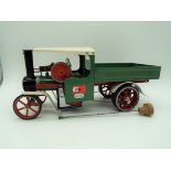 Mamod - a Steam Wagon, green body with red wheels and chassis, cream roof and mudguards,