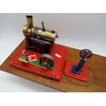 Mamod - a stationary live steam engine and a model power press, both mounted on a wooden base,