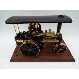 Wilesco Traktor - a live steam traction engine finished in black with brass detailing.