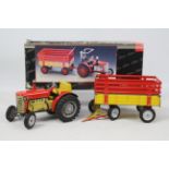 Schuco - A boxed clockwork tinplate Tractor and trailer # 07041.