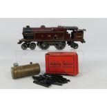 Hornby - A 1930s clockwork tinplate O gauge 4-4-2 tank engine number 2180 in LMS maroon livery.