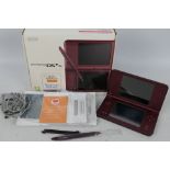 Nintendo - A boxed Nintendo DS XL in Wine Red # 1870546B .