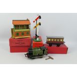 Hornby - An unboxed O gauge clockwork locomotive with three boxed O gauge accessories.