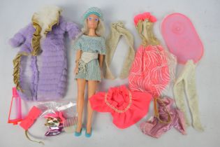 Hasbro - A 1980s Jem doll with a selection of clothing and shoes and stand.
