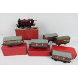 Hornby - A clockwork O gauge locomotive with 5 x coaches in LMS maroon livery,