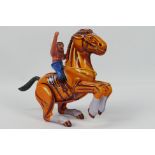 MTU (Korea) - An unboxed and unusual wind-up tinplate toy of' Indian on a Horse'.