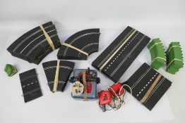 Scalextric - A quantity of 1960s track sections with a power unit and two hand controllers.
