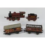 Bing - A rare Bing O gauge 18 volt locomotive with tender numbered 1053 and 2 x LMS Coaches.