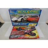 Scalextric - A boxed McLaren MP4-12C set # C1284 and a Scalextric Start Lap Counter set # C8528.