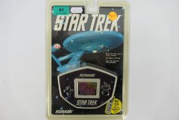 Konami - An unopened 1992 Electronic Star Trek hand held game. The item appears in Mint condition.