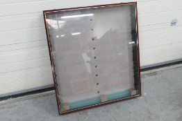 A large wall mounted glass fronted wooden display cabinet with glass shelves.