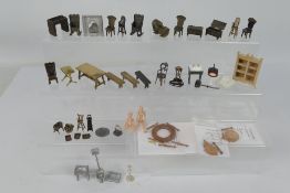 Unknown maker - An unboxed group of unmarked predominately bronze dolls house furniture.