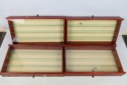 Display Cabinets - Four wooden, glass shelved, wall mounted display cabinets.
