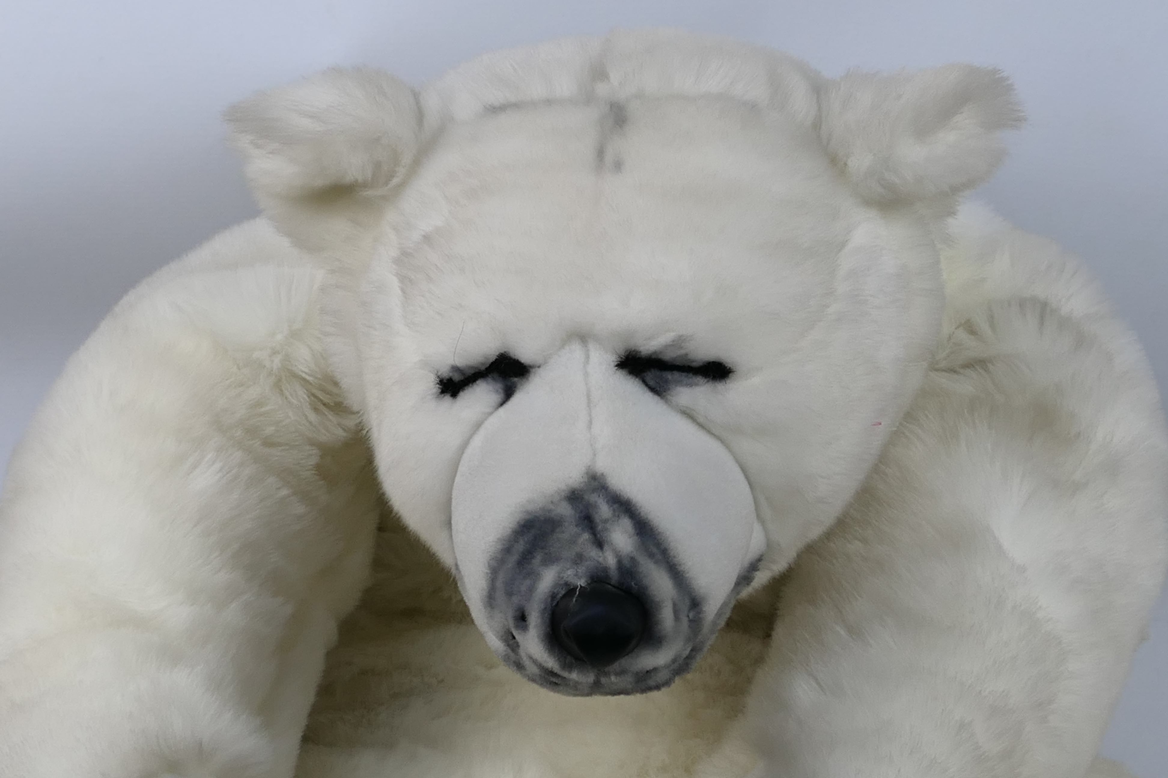 Soft Sensations bear by PMS International - A large plush white bear in sleeping position with what - Image 2 of 3